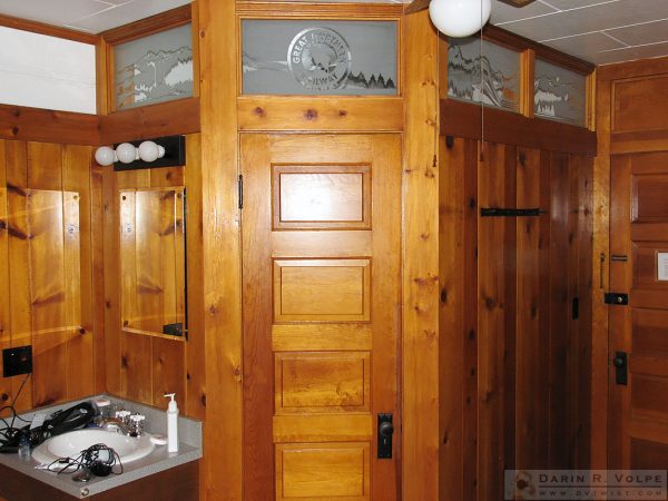 The bathroom built into the room. I love the frosted glass work.