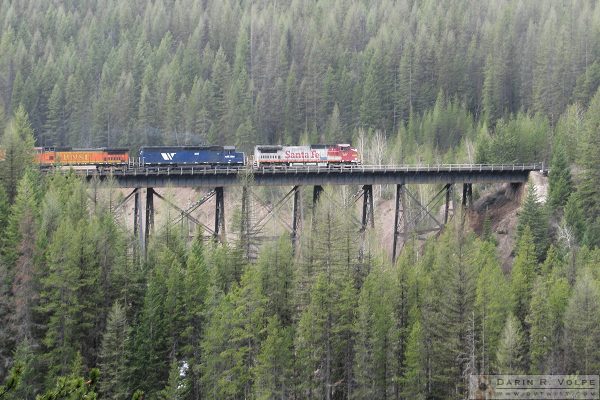 A BNSF locomotive in old Santa Fe paint pulls a train towards Essex.